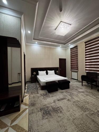 a bedroom with a bed and a television in it at ARK BILLUR HALAL Hotel in Tashkent