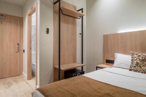 a hotel room with a bed and a closet at Aerohotel Barcelona Airport 24h in El Prat de Llobregat