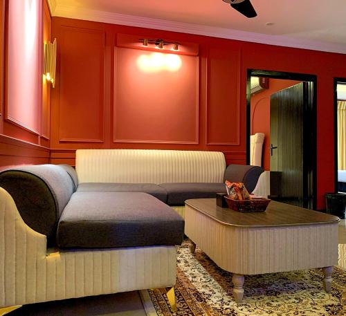 a living room with a couch and a table at Regal Suite by StayMehman in Rawalpindi
