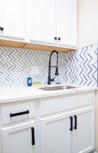 a kitchen counter with a sink and white cabinets at G O G Building in Darby