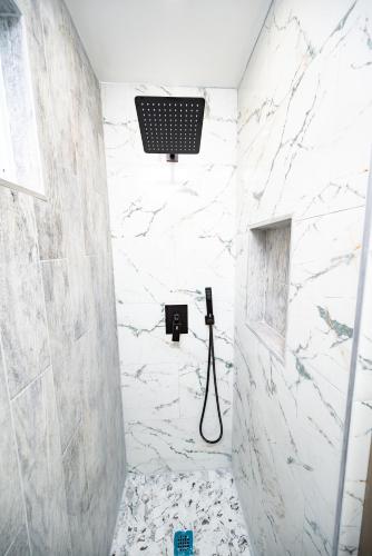 a bathroom with a shower with a stone wall at G O G Building in Darby