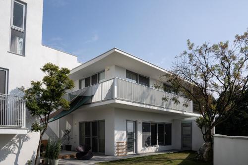 an image of a white house with a balcony at Living In Light in Zhongpu