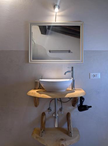 a sink in a bathroom with a mirror at Il Palazzo, Le Fornaci in Sassetta