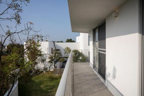 a balcony of a house with a wooden walkway at Living In Light in Zhongpu
