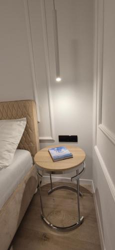 a table with a book on it next to a bed at Anita's Mansion in Gattendorf