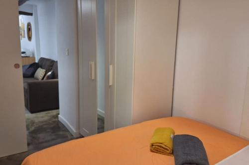 a bedroom with a bed with a yellow towel on it at CSB34 Céntrico Apartamento de diseño in Alcoy