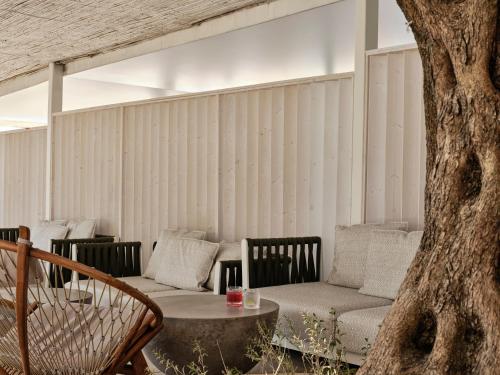 a living room with a couch and a table at Atlantica Nissaki Beach - Adults Only in Gimari