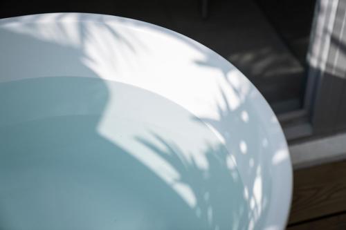 a white plate sitting next to a window at Living In Light in Zhongpu