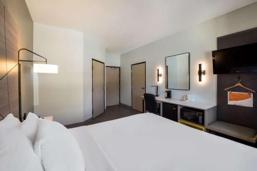 a hotel room with a large bed and a desk at Quality Inn Yuba City-Marysville in Yuba City