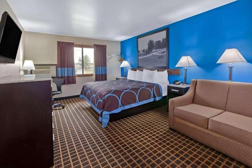 a hotel room with a bed and a couch at Rodeway Inn Elkhart in Elkhart