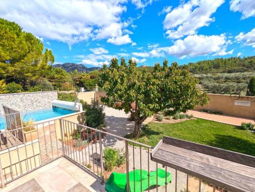 a view of the backyard of a house with a swimming pool at Le Panorama des Alpilles in Aureille