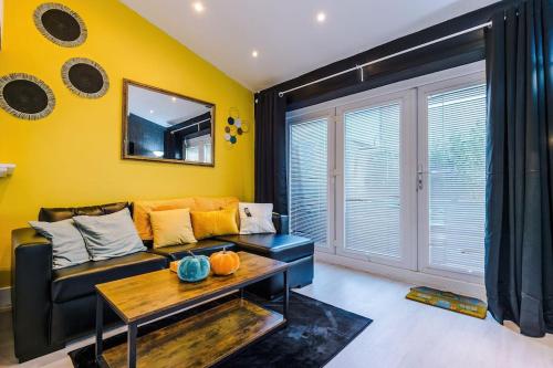 a living room with a couch and a table at Sleeps 7, Games Room, Perfect For Groups, Driveway, Smart TV, Available For Long Stays in Manchester