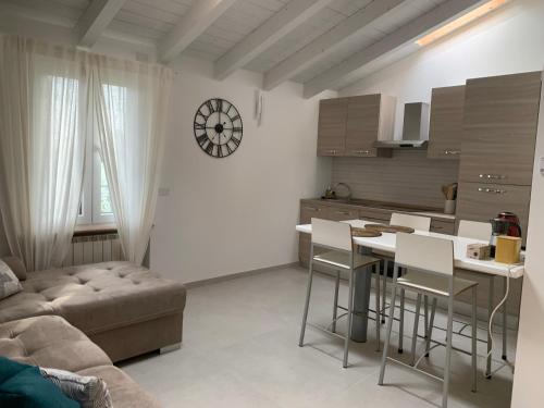 a kitchen with a couch and a table and chairs at Oasi del Po in Monticelli dʼOngina