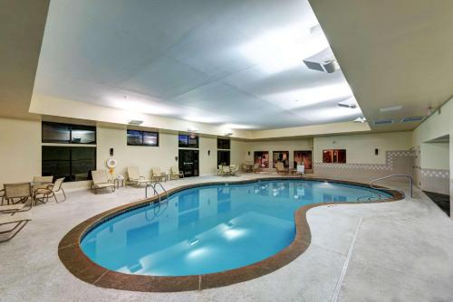 a large swimming pool in a hotel room at Garrison Hotel & Suites Dover-Portsmouth, an Ascend Collection Hotel in Dover
