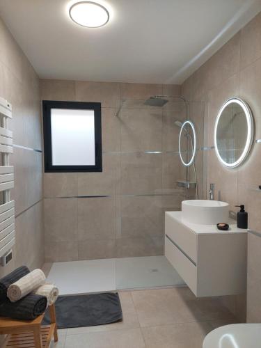 a bathroom with a shower and a sink and a mirror at Terre de Crussol - Gite 3 étoiles en Ardèche, avec piscine et clim, 2-4 personnes in Saint-Péray