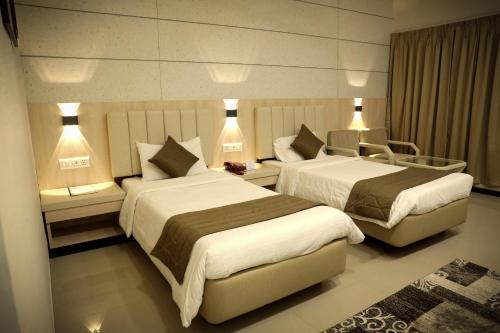 Ένα ή περισσότερα κρεβάτια σε δωμάτιο στο Hotel Yatrik