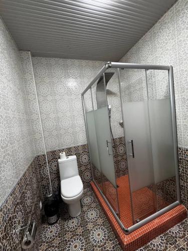 a bathroom with a shower with a toilet in it at ARK BILLUR HALAL Hotel in Tashkent