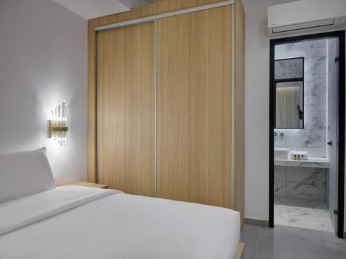 a bedroom with a bed and a bathroom with a sink at Villa Christy in Psarou