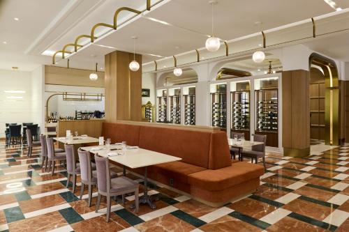 a restaurant with tables and chairs and a couch at Grand Mercure Imperial Palace Seoul Gangnam in Seoul
