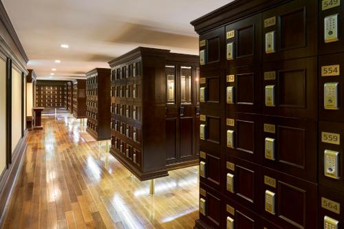 a library with many wooden cabinets in a room at Grand Mercure Imperial Palace Seoul Gangnam in Seoul