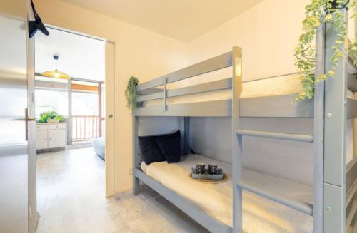 Ce lit superposé se trouve dans un dortoir doté d'un couloir. dans l'établissement Appartement T2 Hyper Centre RoLéo, à Saint-Lary-Soulan