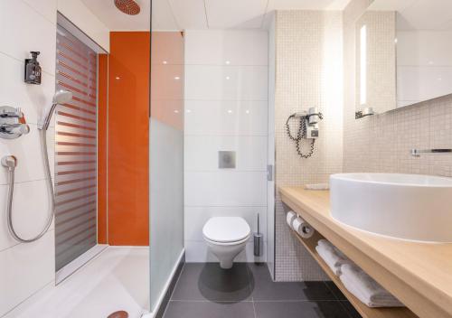 a bathroom with a sink and a toilet at Fletcher Hotel-Restaurant Nieuwegein-Utrecht in Nieuwegein