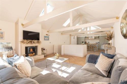 a living room with a couch and a fireplace at Luxury stay in centre of historic Stamford in Lincolnshire
