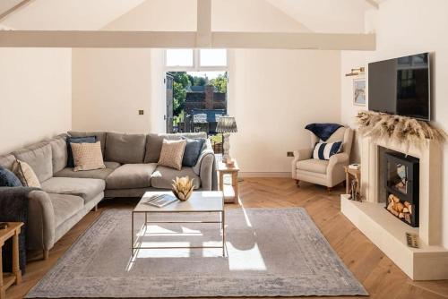 a living room with a couch and a fireplace at Luxury stay in centre of historic Stamford in Lincolnshire