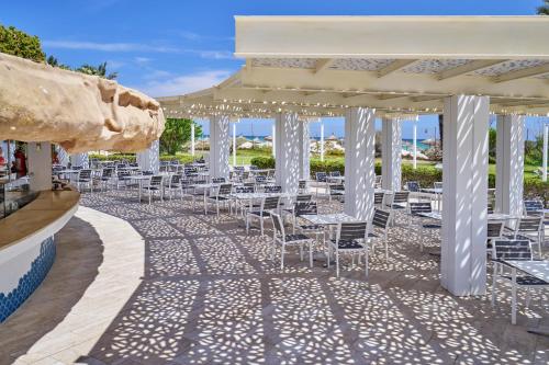 a row of tables and chairs under a pavilion at Mahdia Beach & Aqua Park in Mahdia