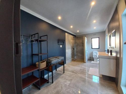 a bathroom with a sink and a toilet in a room at Comfortable and luxurious stay in Gweru