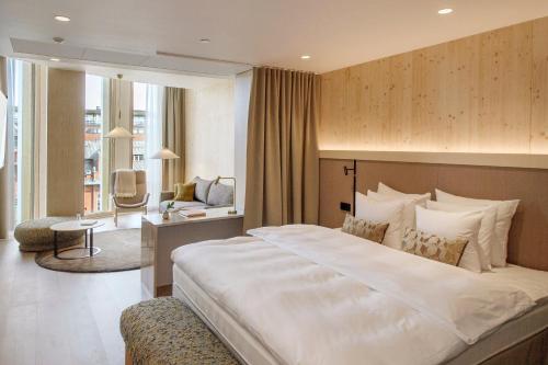 a bedroom with a large bed and a living room at Solo Sokos Hotel Pier 4 in Helsinki