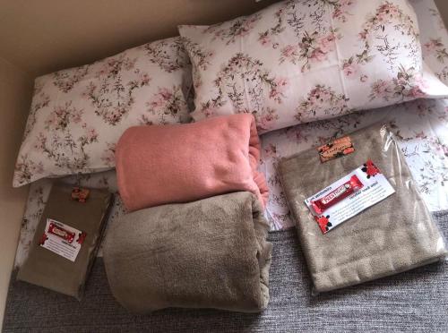 un letto con cuscini e coperta e alcune borse di Casa de campo a Paty do Alferes