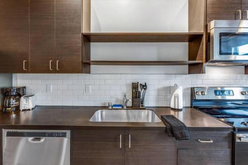 a kitchen with a sink and a stove at Roxy Condo #203 in Bremerton