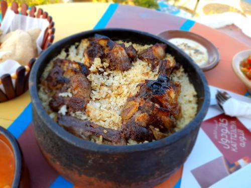 a bowl of food sitting on a table at Dolty Kato Nubian House By Kato Dool in Aswan