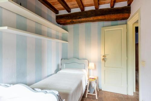 a bedroom with two beds and a white door at Greg's House in Santa Lucia