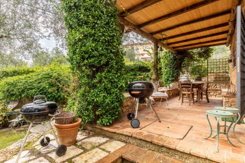 a patio with two bbqs and a grill at Greg's House in Santa Lucia