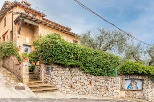 a stone building with a painting of a woman on it at Greg's House in Santa Lucia
