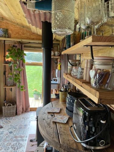 a kitchen with a wooden table in a room at Pear Tree Hut at Carr house farm in Scarborough