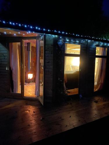 a house with a lit up window at night at Pear Tree Hut at Carr house farm in Scarborough
