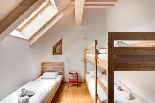 two bunk beds in a room with white walls at Apartment Pr Cirklu, Kranjska Gora in Kranjska Gora