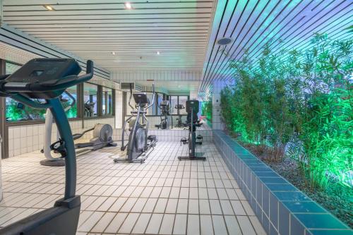 a gym with exercise equipment and an indoor garden at Fletcher Hotel-Restaurant Nieuwegein-Utrecht in Nieuwegein