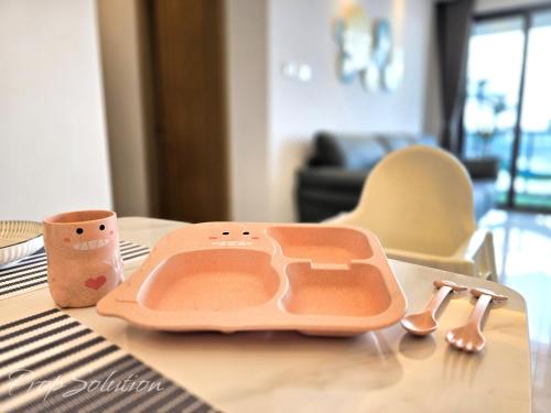 a tray sitting on top of a table with a spoon at Cozy Seaview Suite Johor Bahru CIQ in Johor Bahru