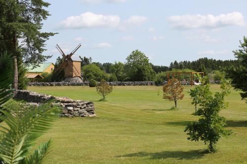a field with a mill and a windmill at Stiilne majake saunaga in Kuusiku