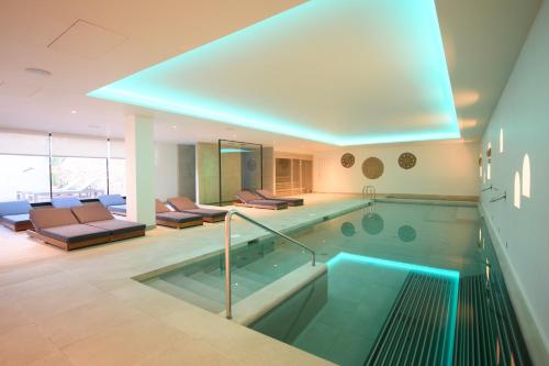 a large swimming pool in a house at Hotel & Spa Blau Parc in San Antonio