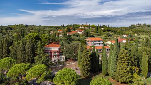 an aerial view of a town with trees and houses at Hotel Laguna - Terme Krka in Strunjan