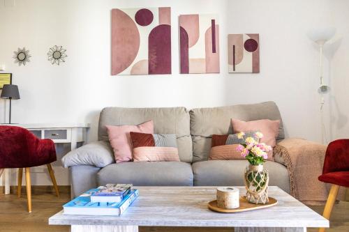 a living room with a couch and a coffee table at Apartamentos rurales Posada de Monfragüe con jacuzzi in Malpartida de Plasencia