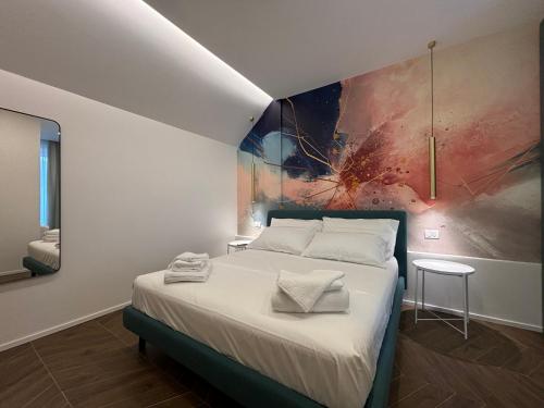 a bedroom with a bed with a painting on the wall at elegant Bike&Moto Haven in Gavardo