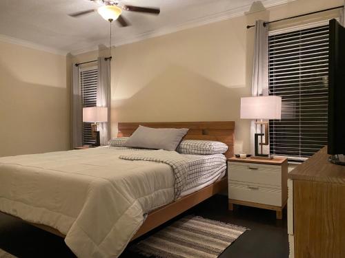 a bedroom with a bed and a ceiling fan at Cozynest2 in Boynton Beach