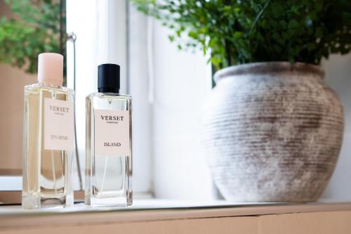 two bottles of perfume sitting on a window sill at 24 Kingsford Court in Newton Mearns