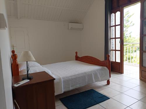 Postel nebo postele na pokoji v ubytování L'ASETA Paradise
